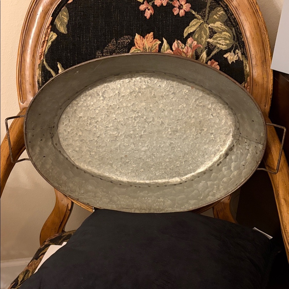 Galvanized Distressed Metal Oval tray with handles and hammered finish.